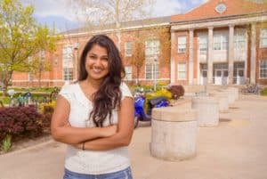 Thilini standing in front of Violette Hall on the Truman State University campus