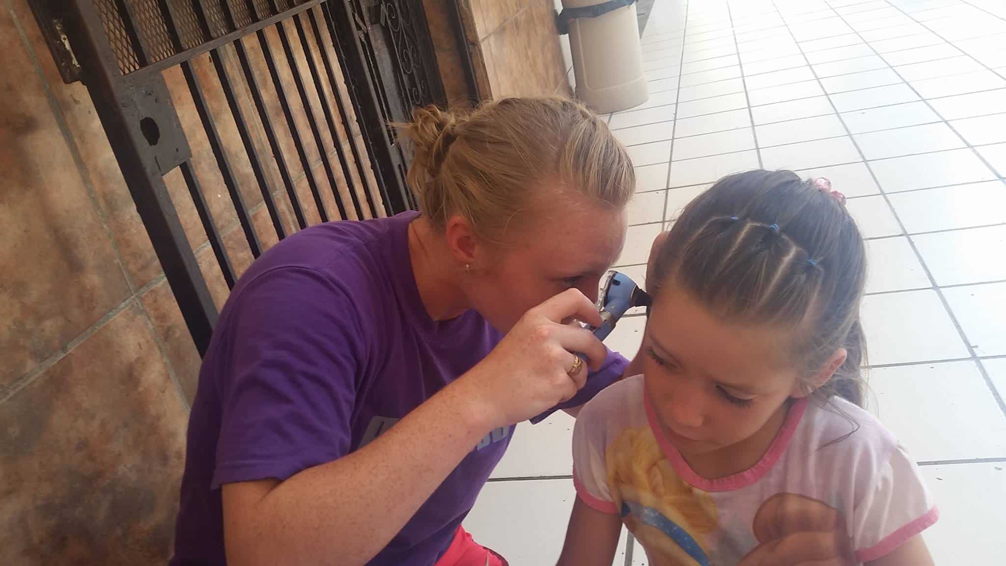 Mackenzie uses otoscope