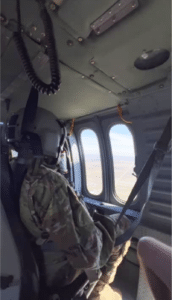 Students seated in Black Hawk helicopter looking out windows